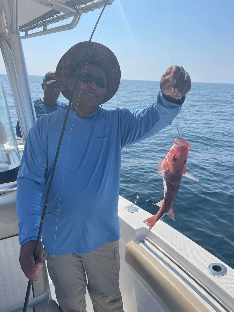 Angler with fishing rod at unknown location