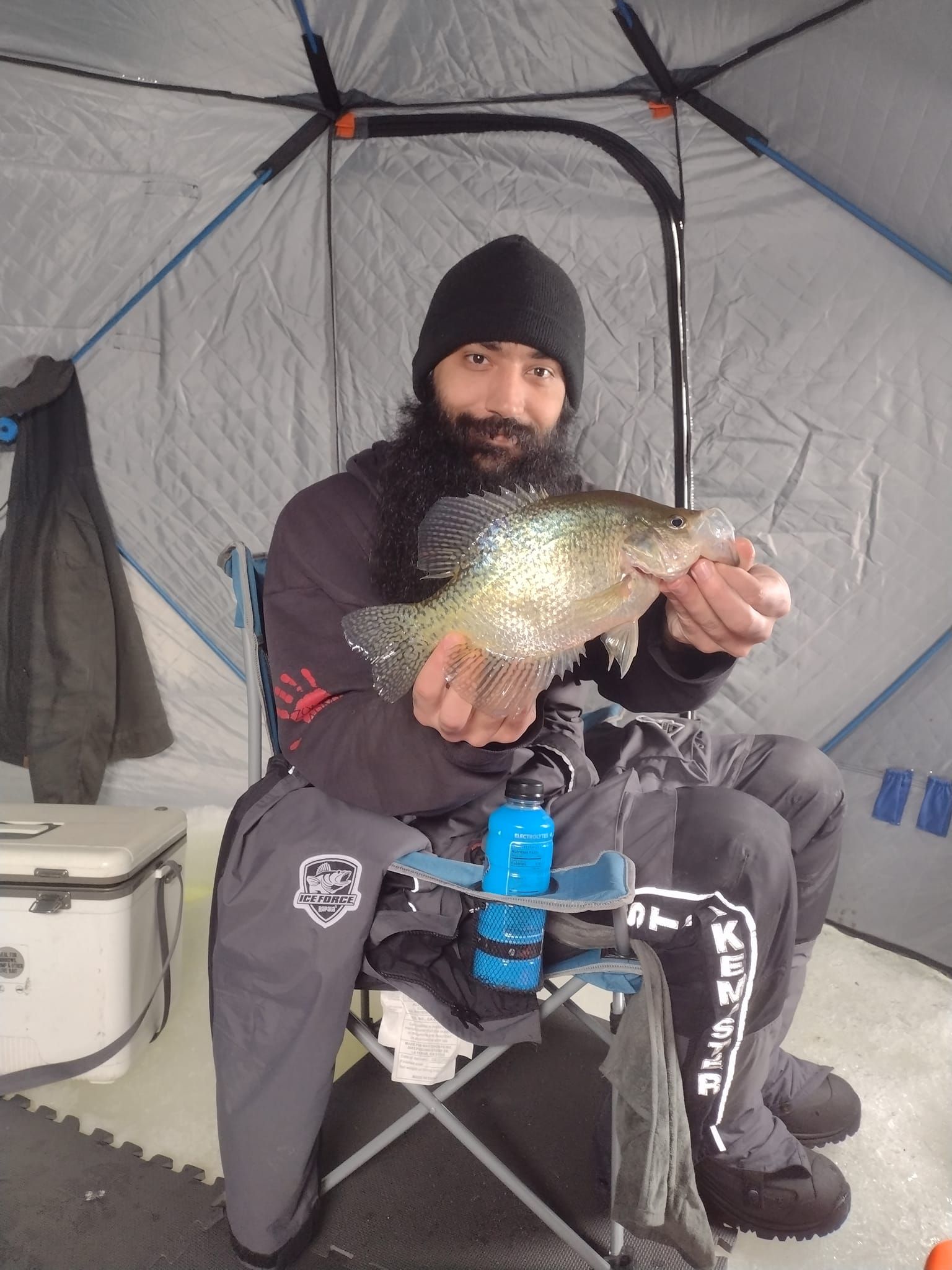 Angler holding large fish in unknown location