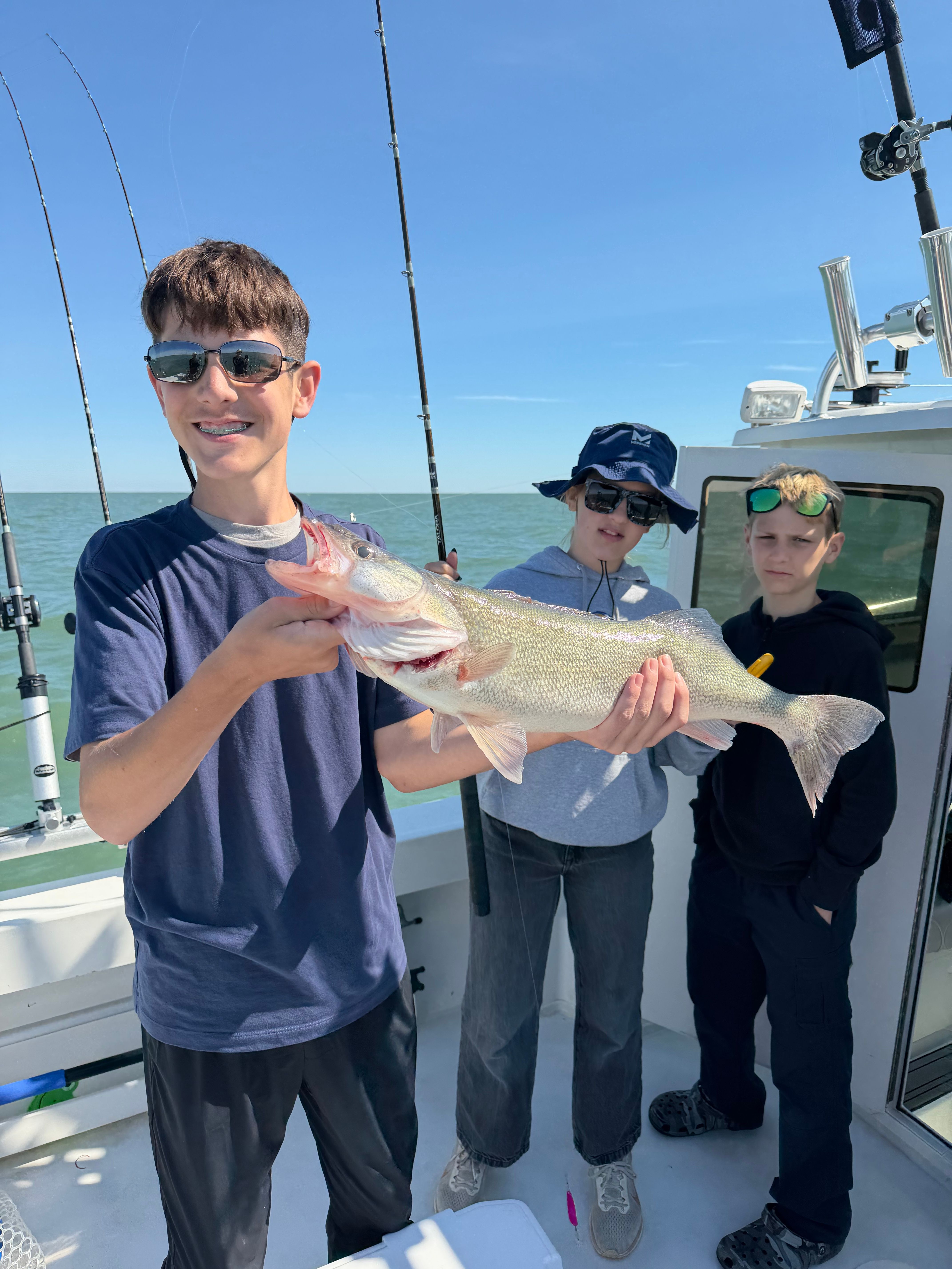 Freshly caught walleye being displayed on fishing boat during outdoor fishing trip
