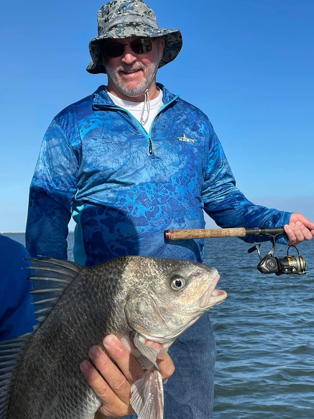 Angler with a black drum fish