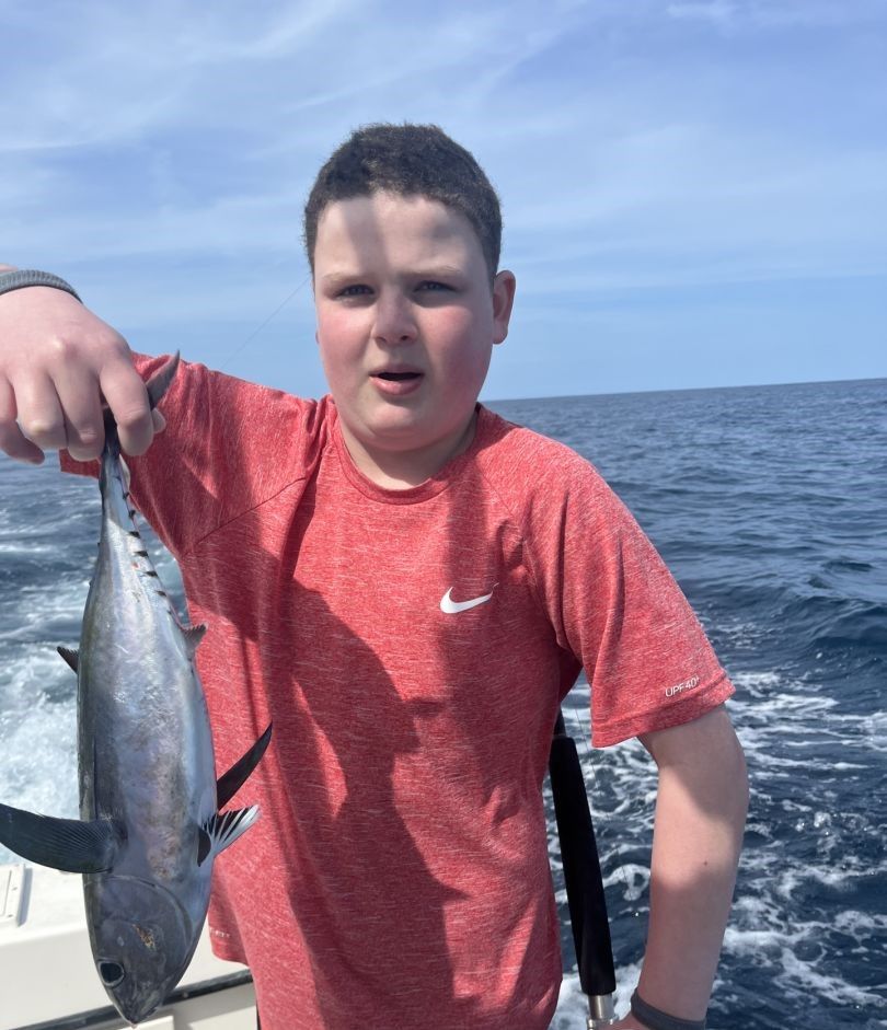 A person fishing at an unknown location