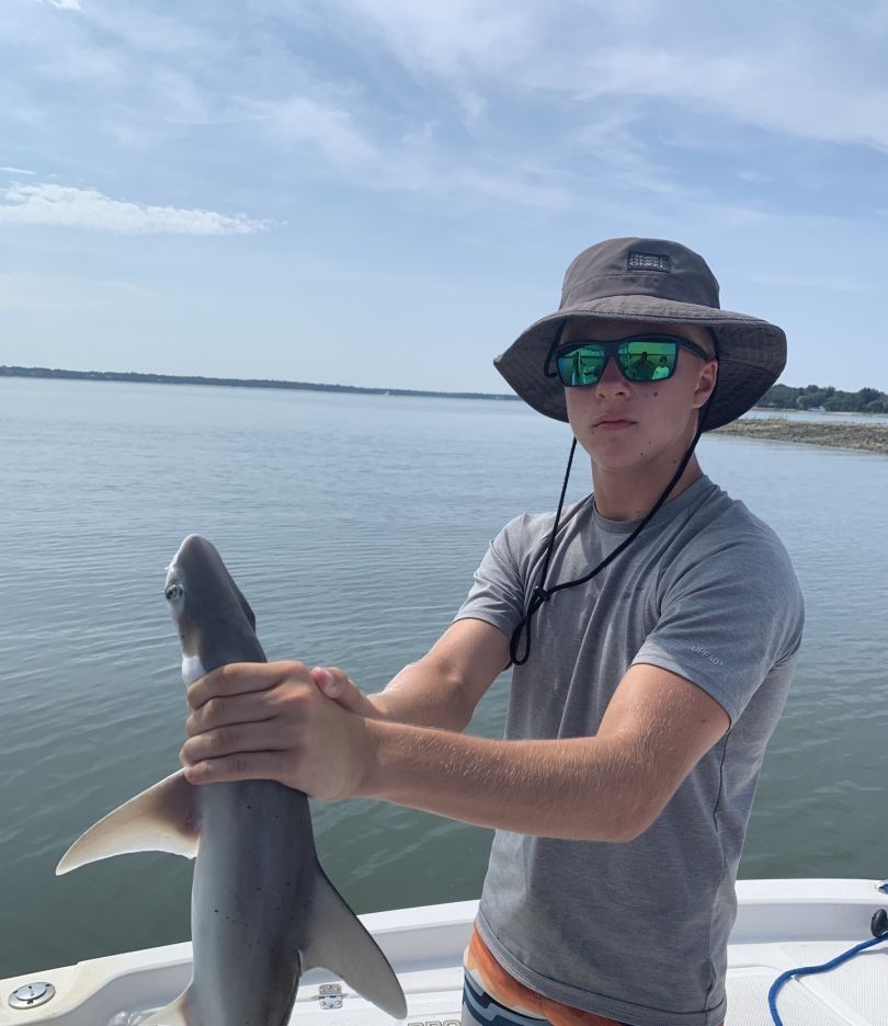 A lone angler fishing in an unknown location