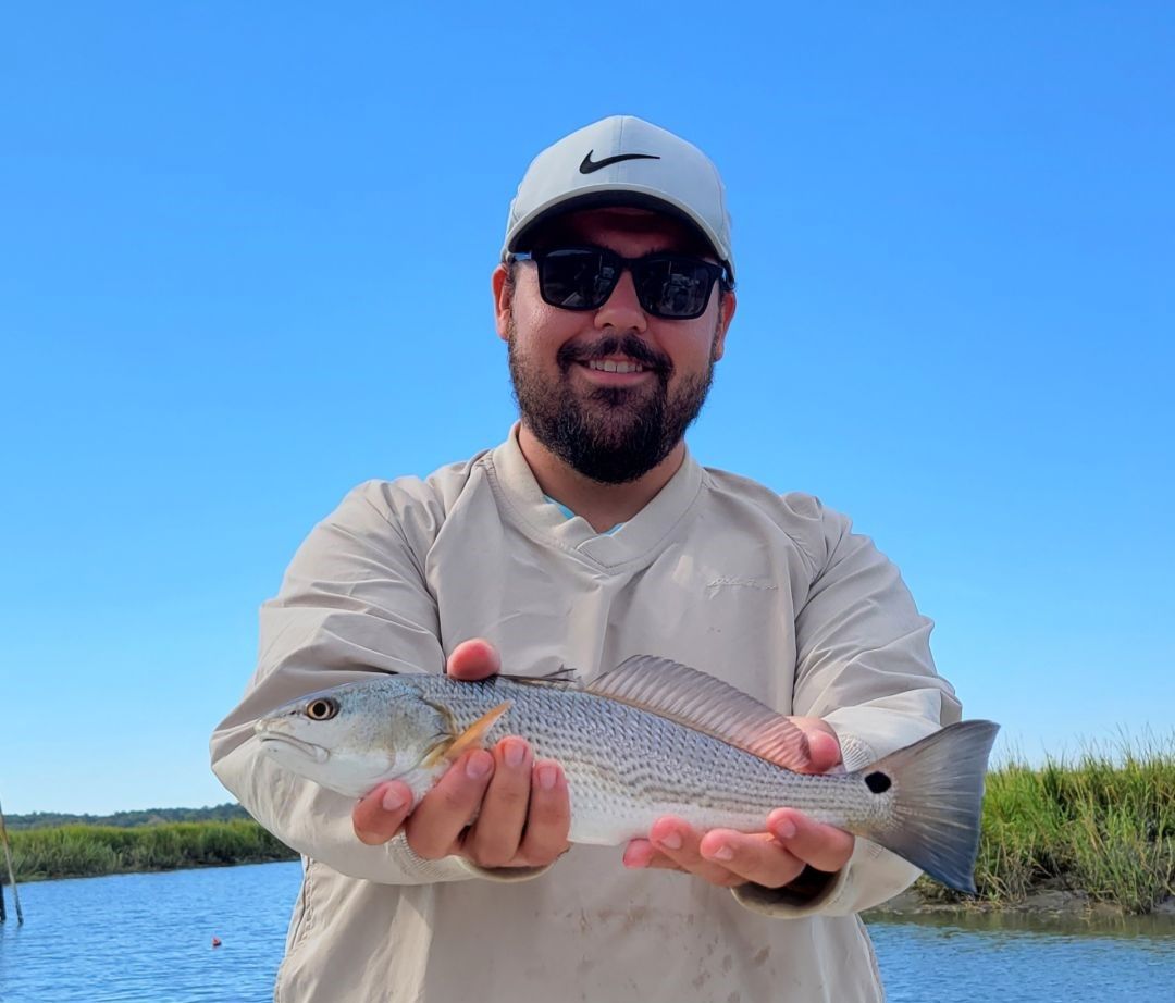 Angler with a 15-inch redfish