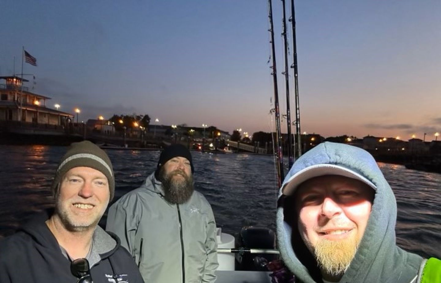 Three anglers enjoying a fishing trip at an unknown location