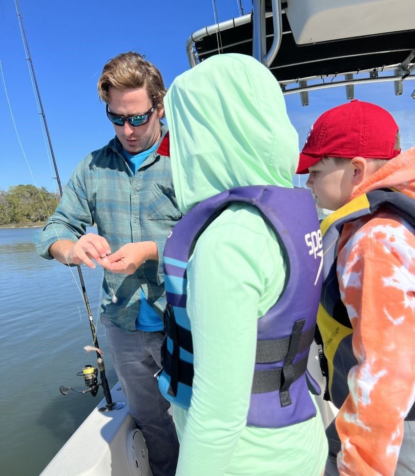 Two people fishing in an unknown location