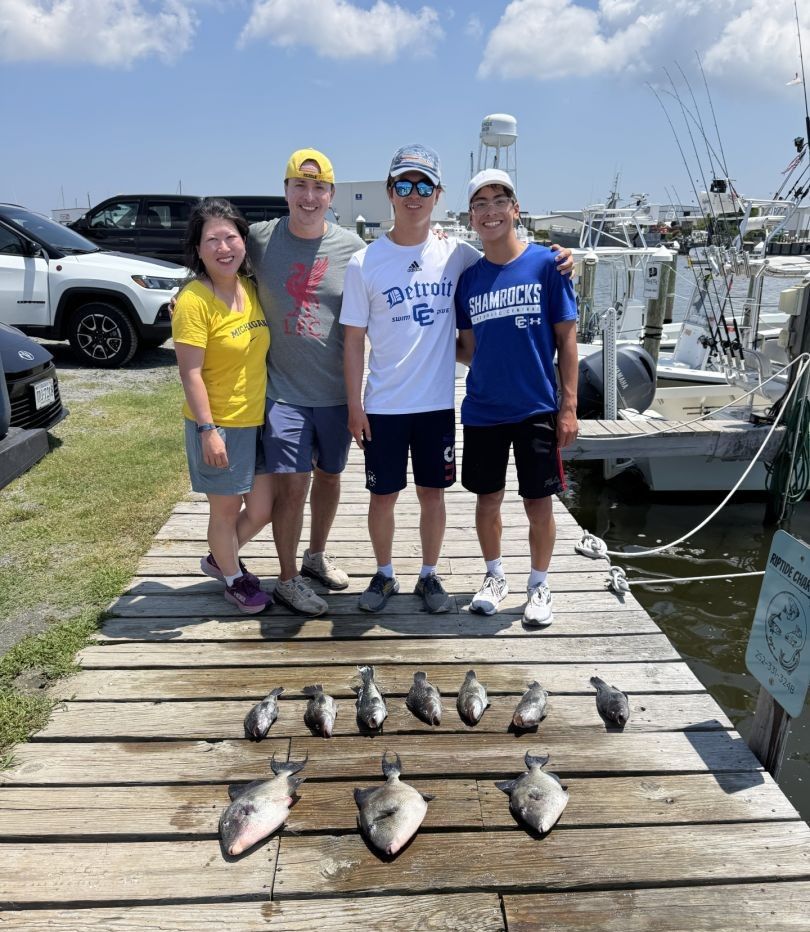 Four anglers fishing at a scenic location