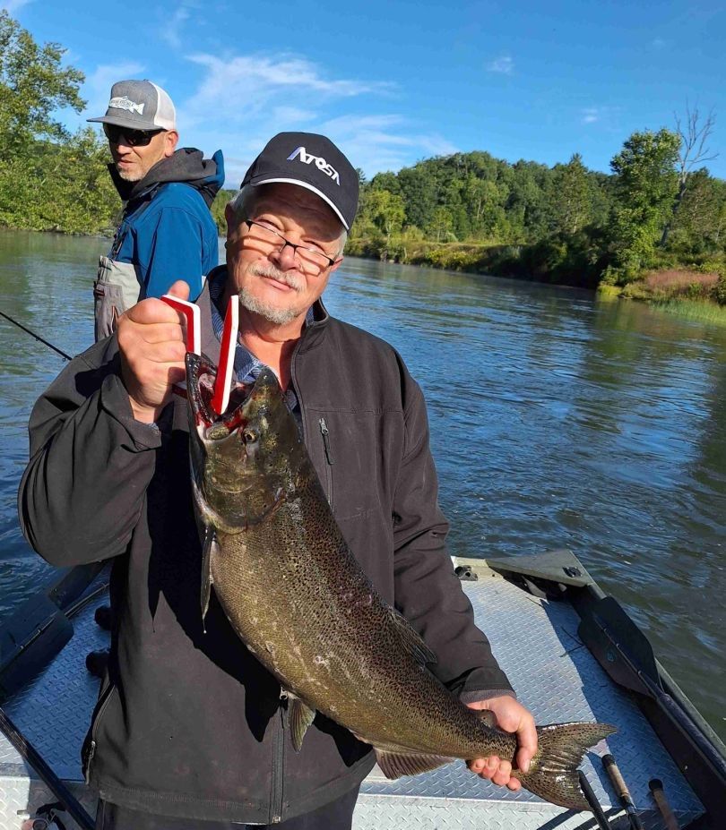Angler catching a rainbow trout