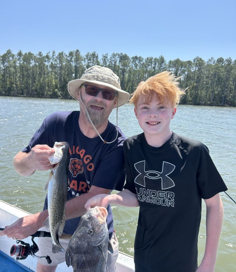 Two anglers fishing for black drum in an unspecified location.