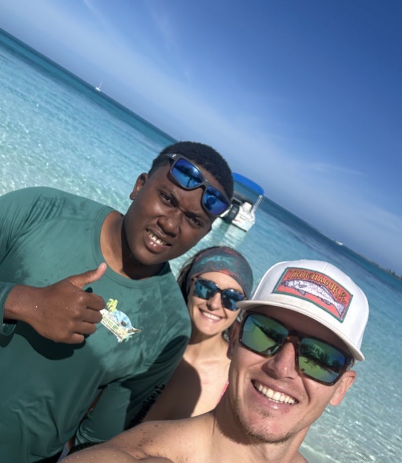 Group of 4 people fishing at an unknown location