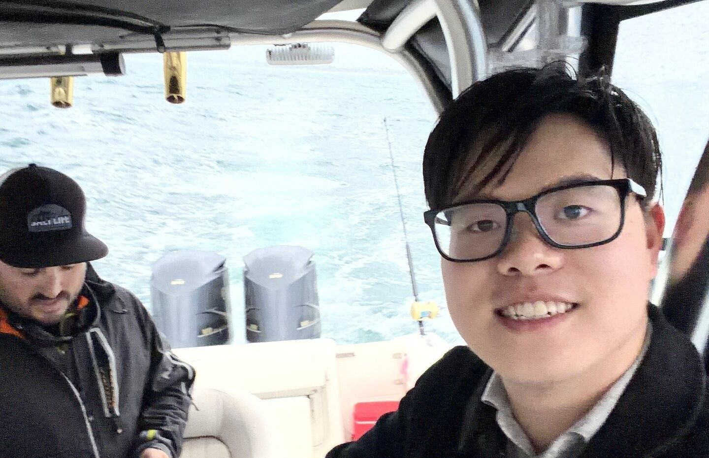 Boat cabin interior with water and marine equipment visible through windows