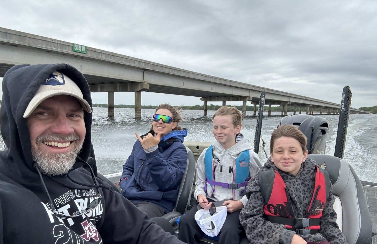 Boat traveling under bridge on water during outdoor boating excursion