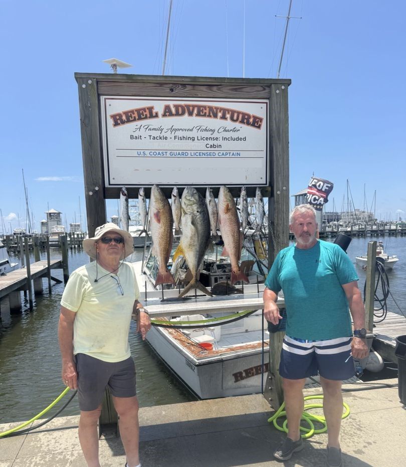 Fresh caught crevalle jack and redfish displayed on fishing charter boat at marina dock