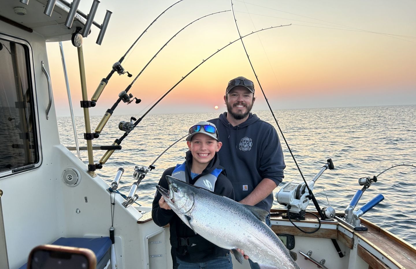 Chinook salmon caught on fishing boat during sunset on open water