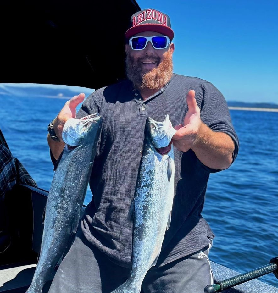 Fresh caught coho salmon displayed on fishing boat deck on open water