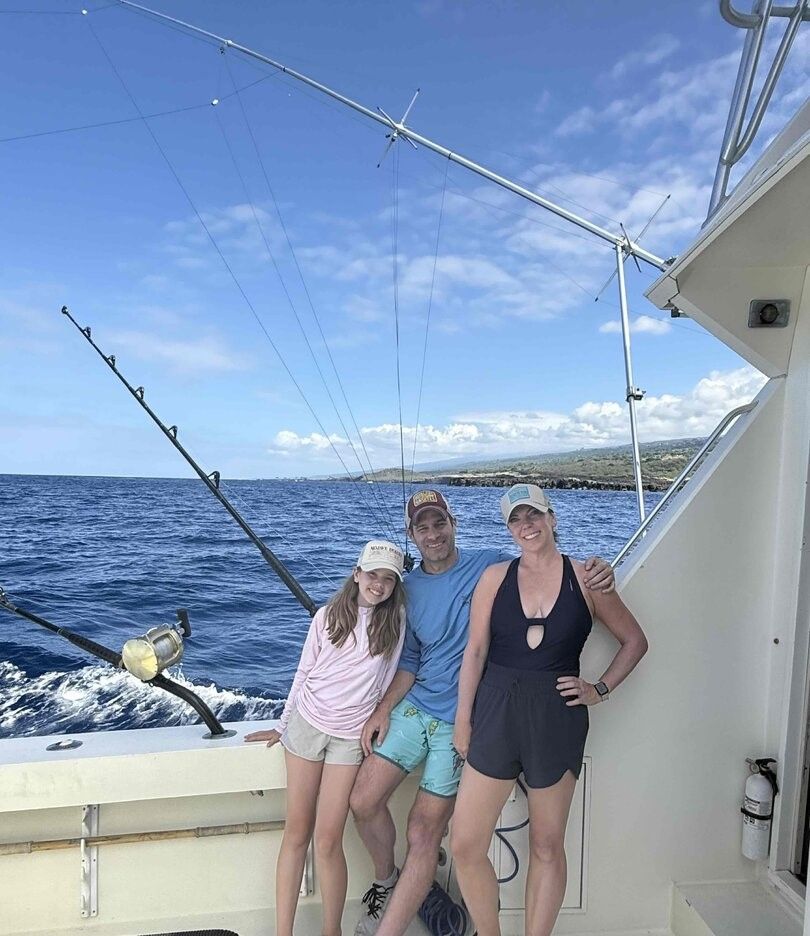 Deep sea fishing charter boat on open ocean waters with fishing equipment and outriggers deployed