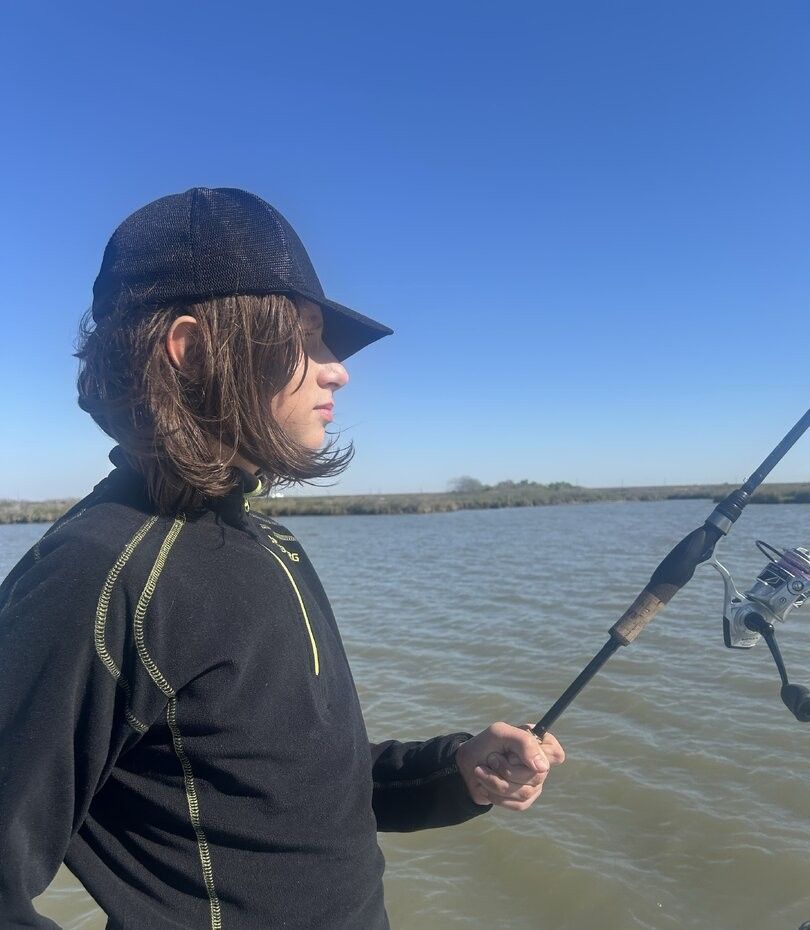 A person fishing at an unknown location