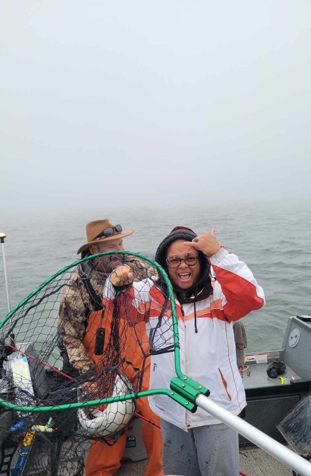 Two people fishing in an unknown location