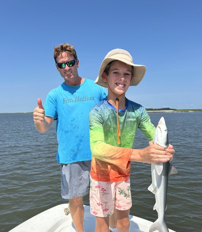 A person fishing with a rod in an unspecified location.