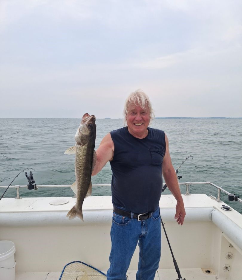 A person fishing in an unknown location