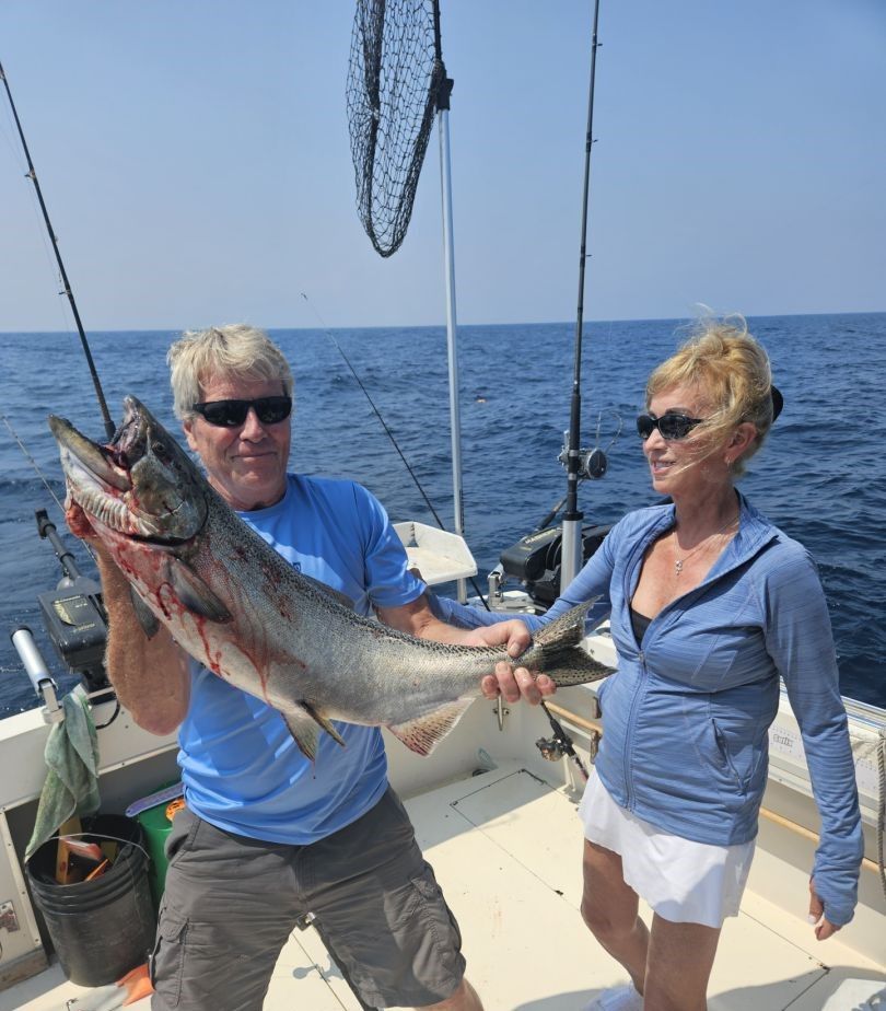 Two people fishing at unknown location