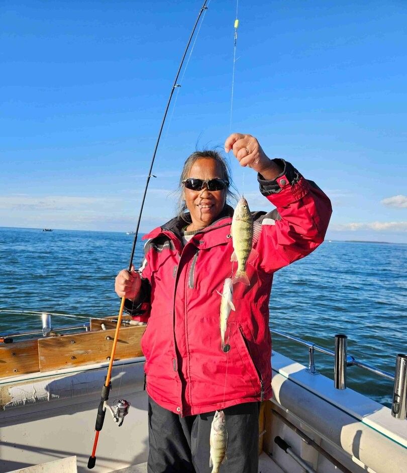 A person fishing at an unknown location