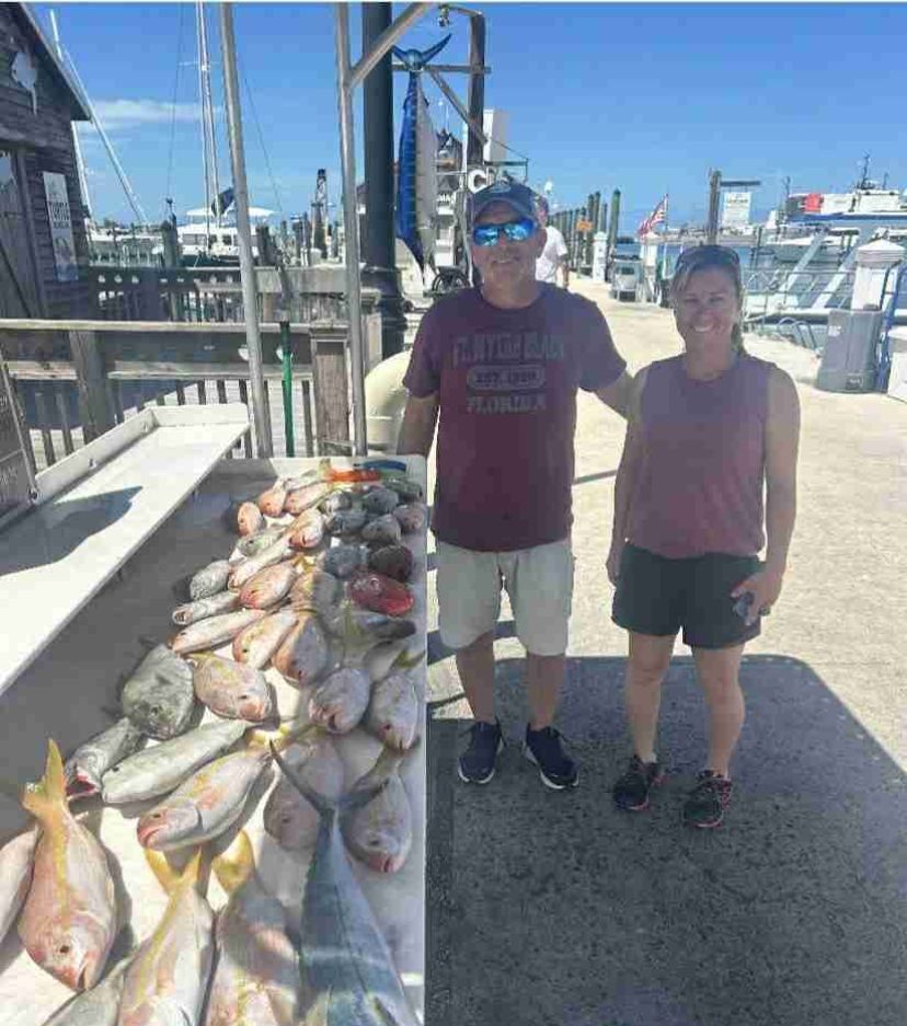 Two people fishing at unknown location