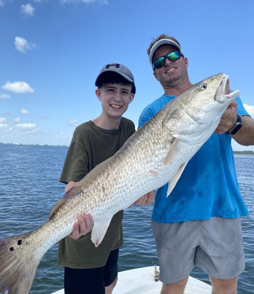 A fisherman with a big catch at an unknown location