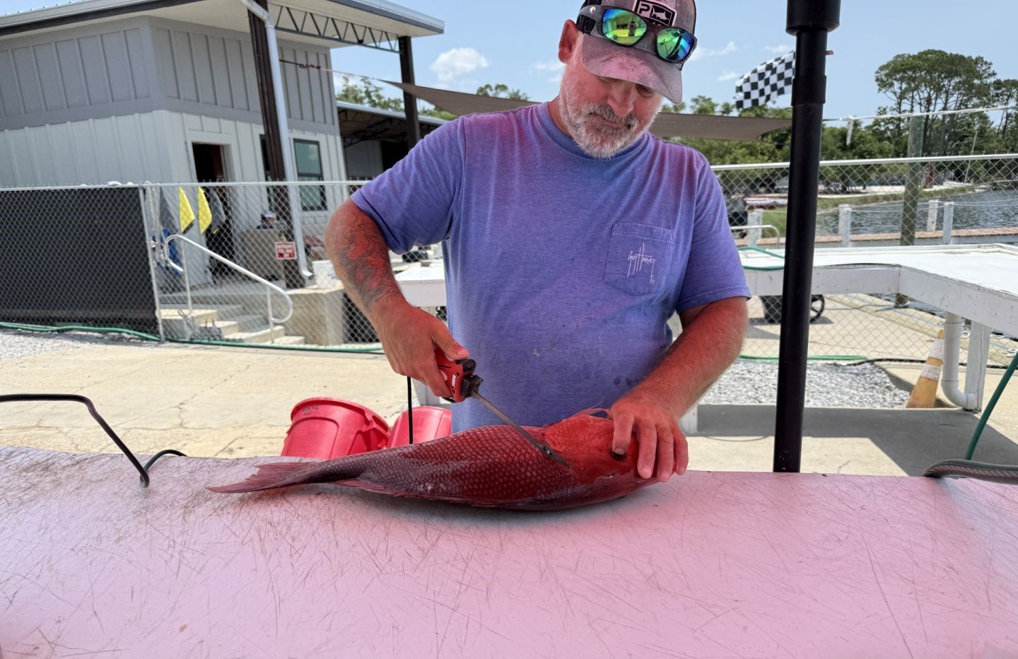 A person fishing in an unknown location