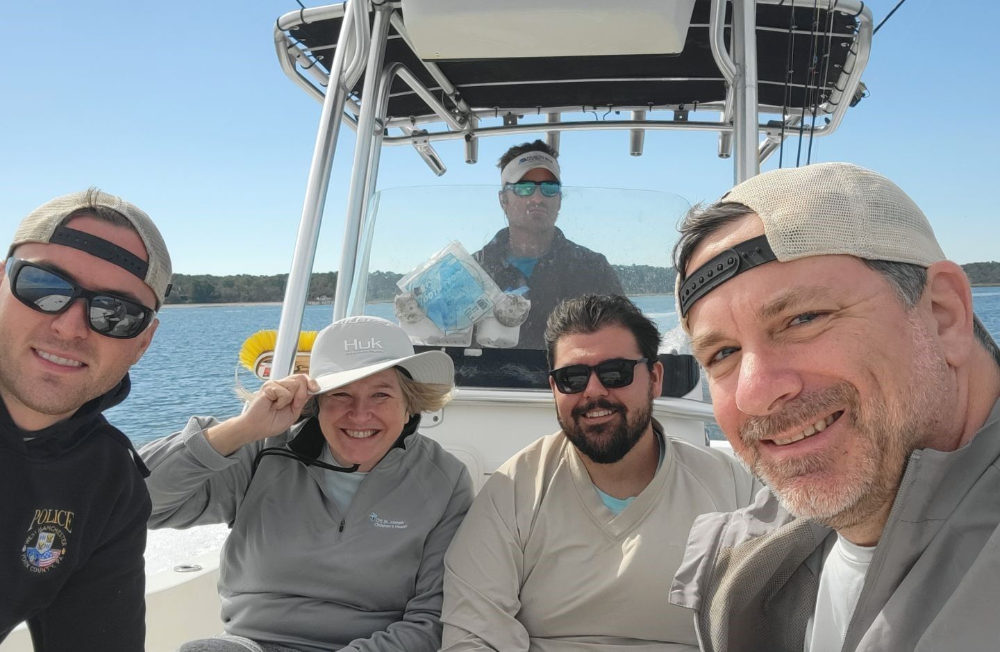 Five people enjoying fishing in an unknown location