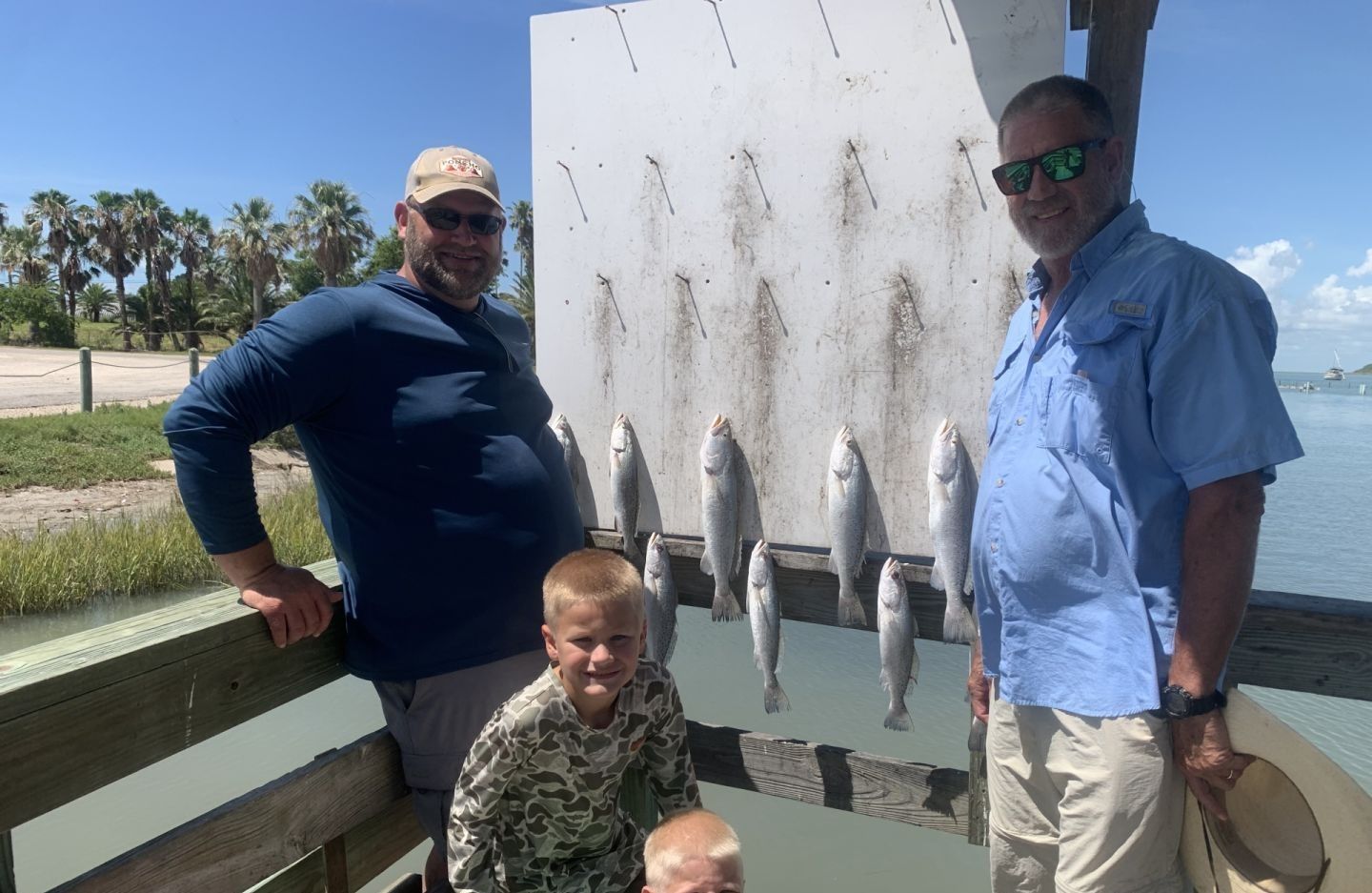 Three people fishing in an unknown location