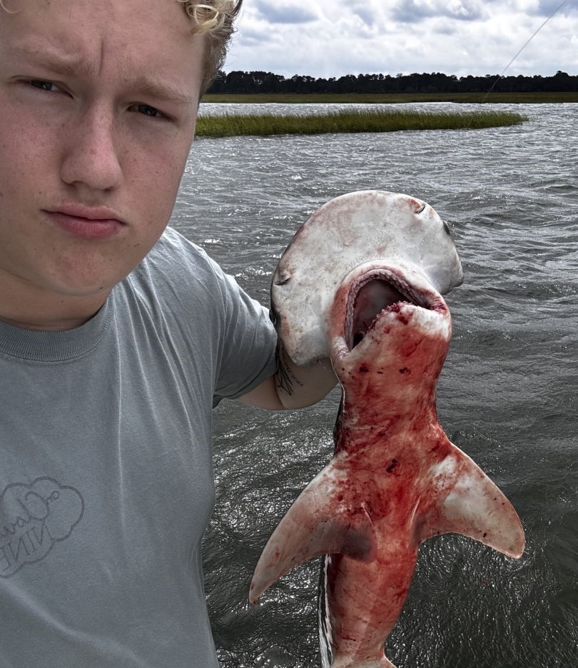A person fishing in an unknown location
