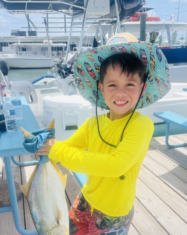Fresh caught fish displayed on fishing boat deck at marina