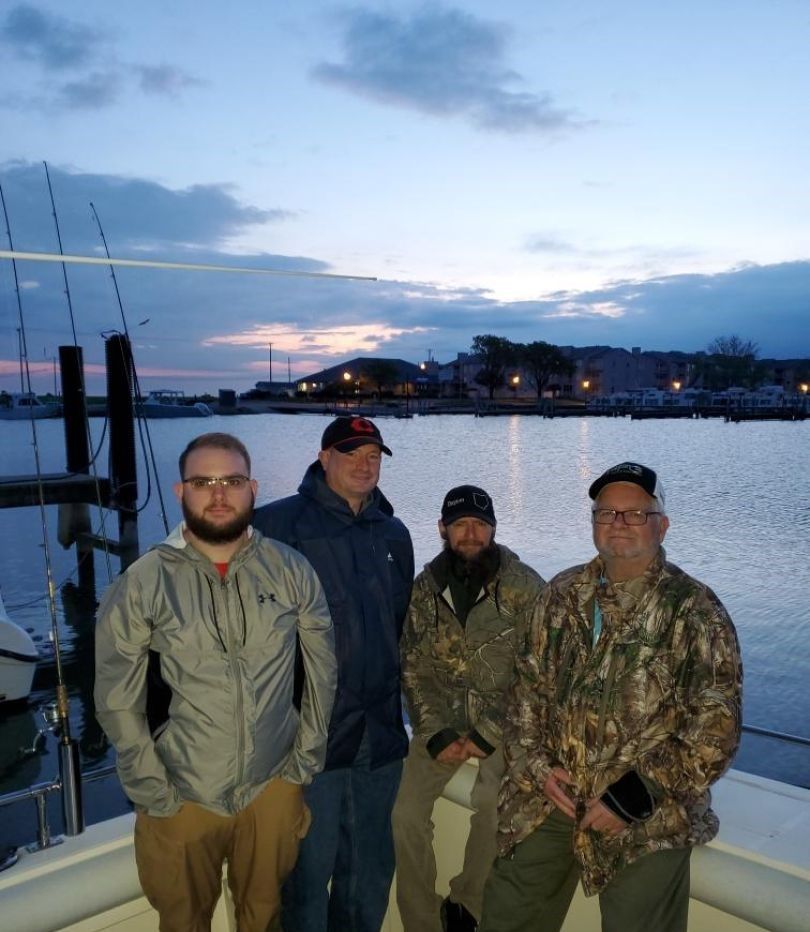 Group of 4 people fishing at an undisclosed location