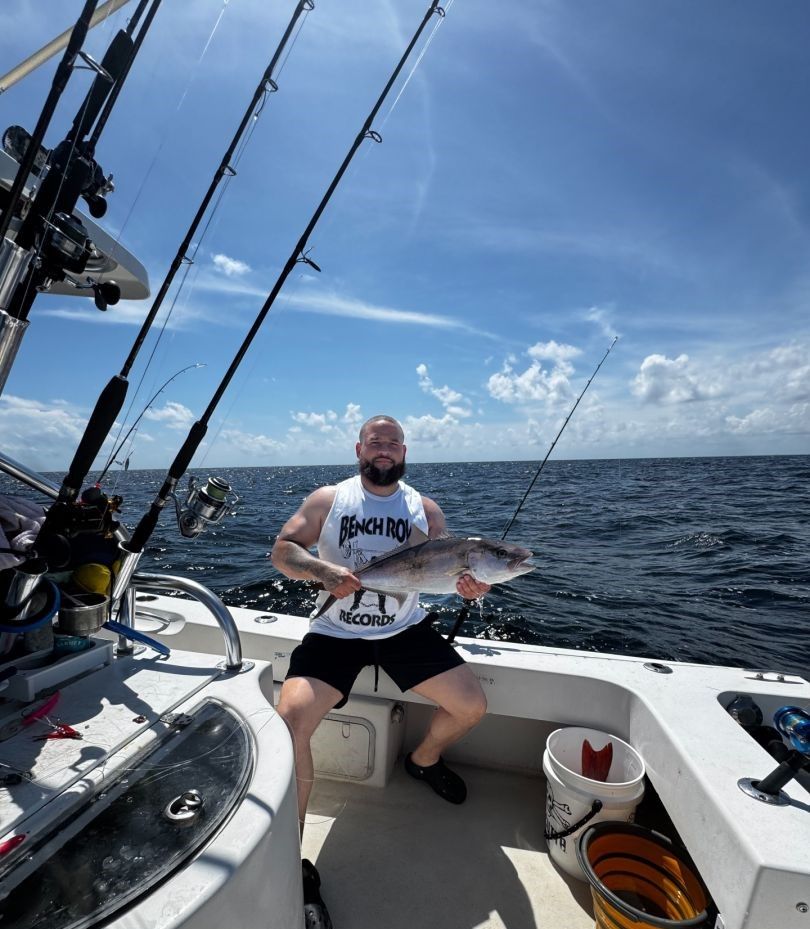 Greater amberjack caught during offshore fishing trip on boat