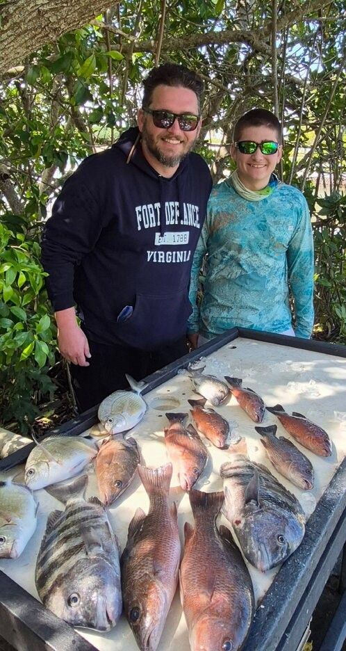 Successful fishing trip displaying fresh caught grey snapper and sheepshead on ice