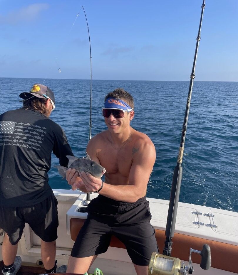 Grey triggerfish catch displayed on fishing boat deck over ocean waters