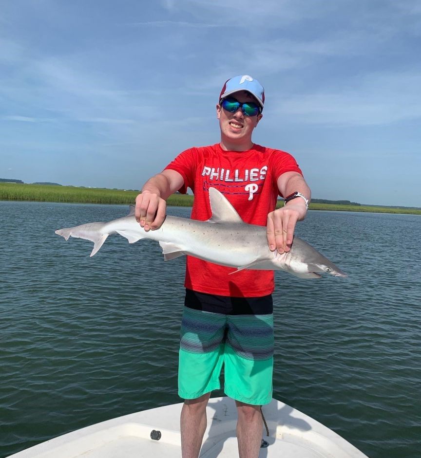 An angler catches a 33-inch fish