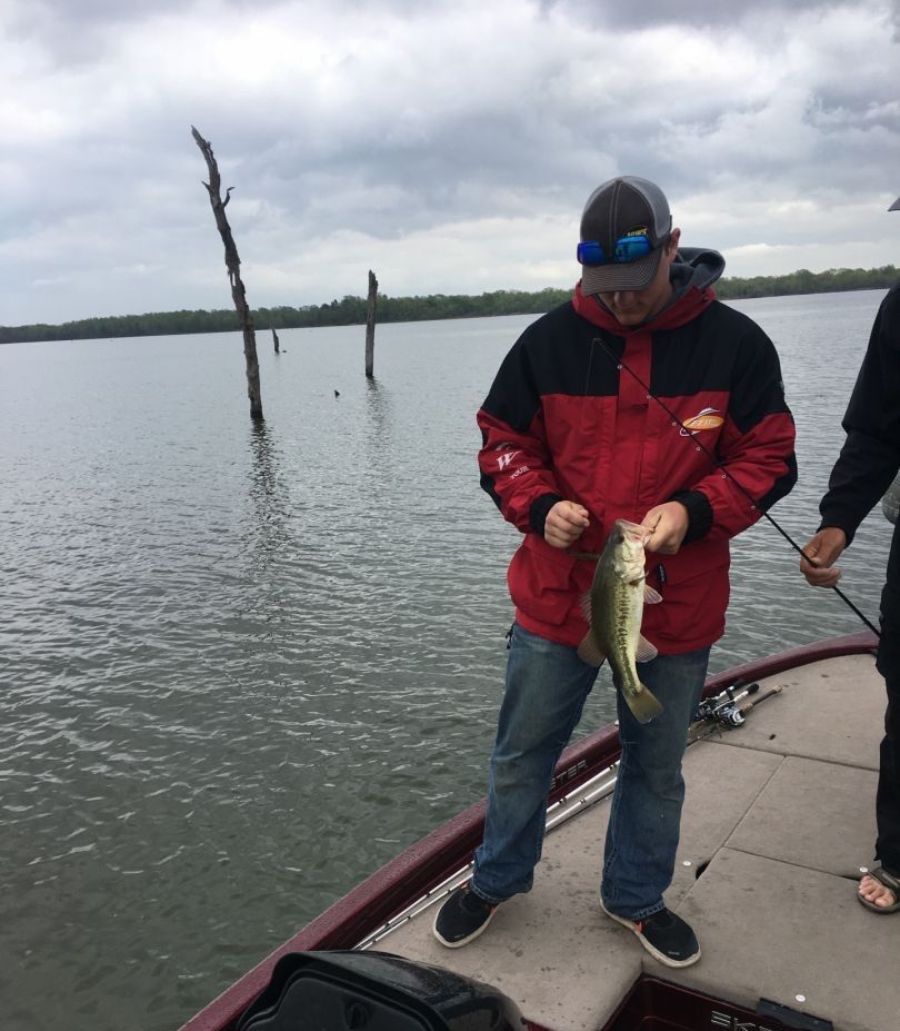Angler holding a largemouth bass