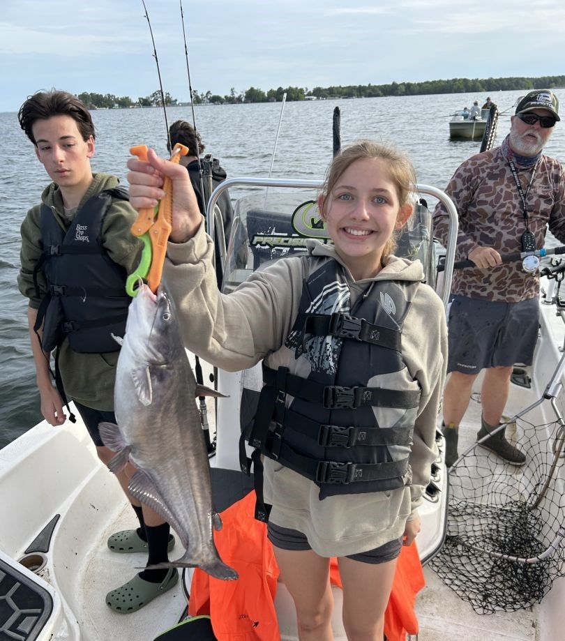 A single blue catfish caught by 3 people