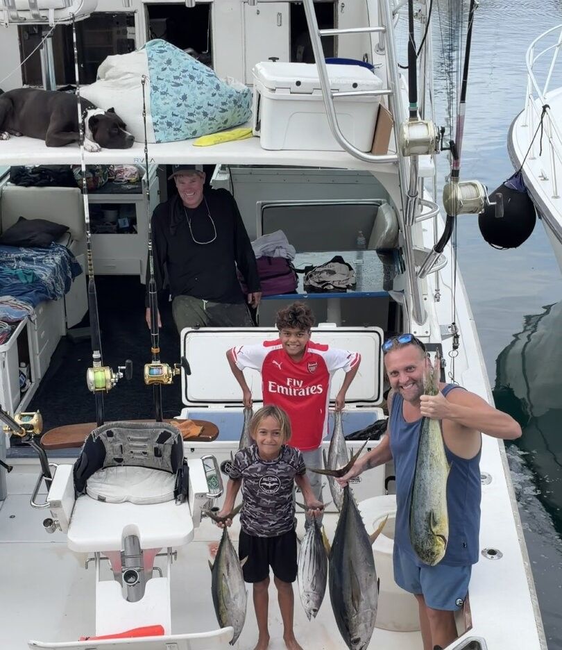 Fishing boat deck with caught blackfin tuna, mahi mahi, and skipjack tuna displayed on deck