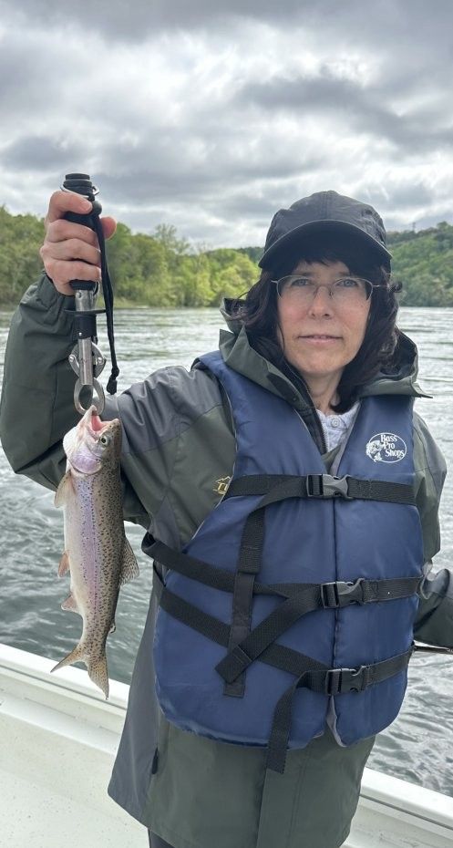 Angler with a rainbow trout fish