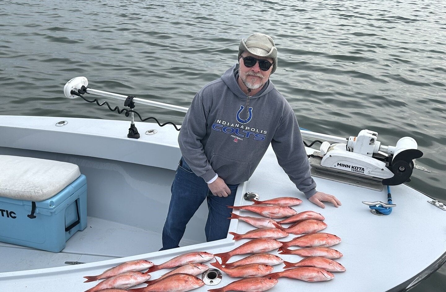 Fresh caught red fish displayed on boat deck after successful fishing trip