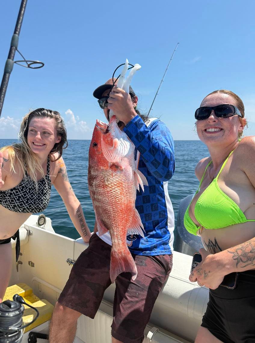 Fresh caught red snapper displayed on fishing boat deck in open ocean waters