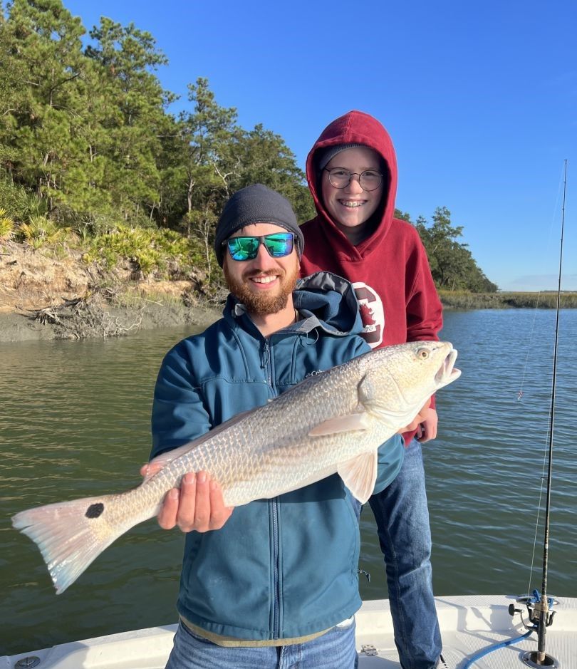 Redfish, a 26-inch saltwater game fish, caught by two people while fishing