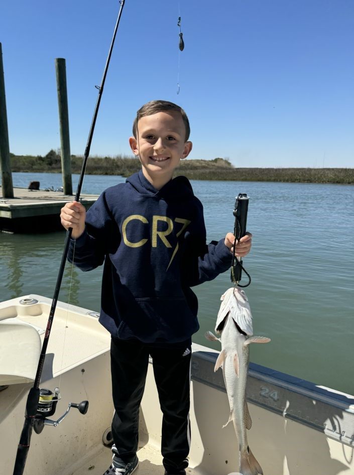 Successful redfish catch displayed on fishing boat