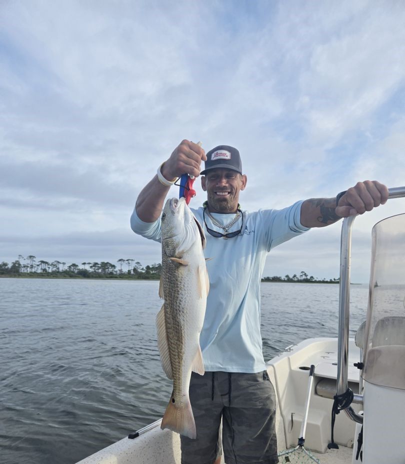 Angler catching a red redfish