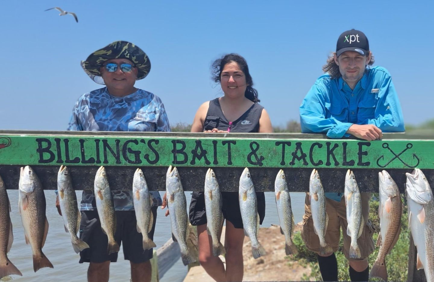 Successful fishing trip displaying multiple redfish and speckled trout caught outdoors