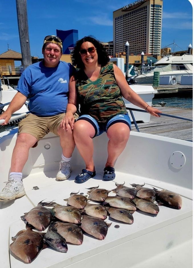 Two people fishing in an unknown location