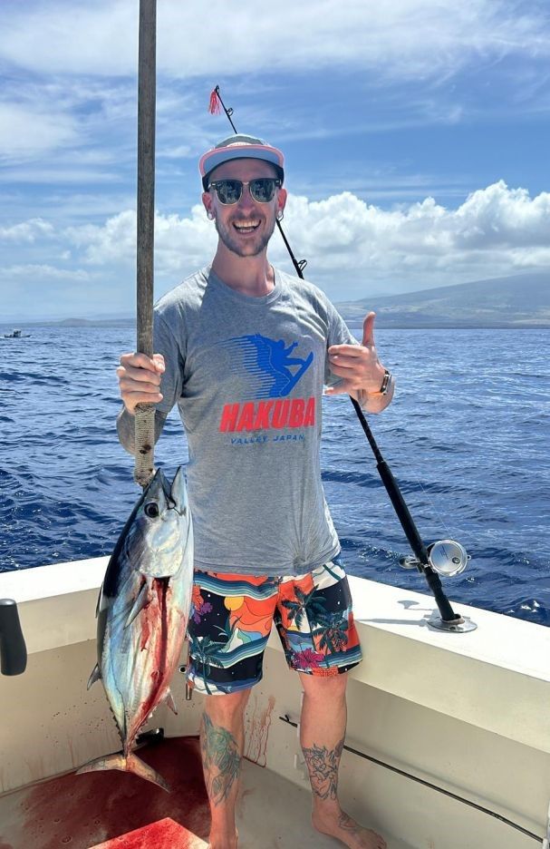 Freshly caught skipjack tuna displayed on fishing boat deck over ocean waters