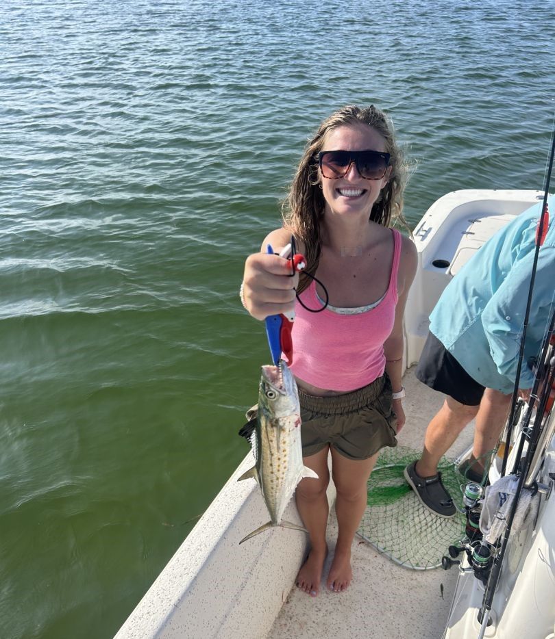 Angler catching a Spanish Mackerel fish while fishing